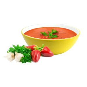 A bowl of soup with some vegetables on the side