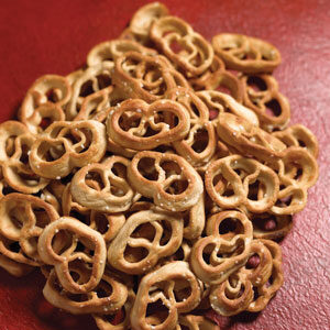 A pile of pretzels sitting on top of a red table.