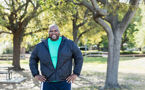 A man standing in front of some trees