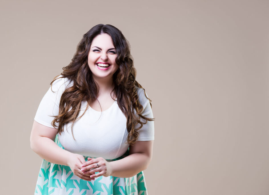 A woman with long hair and a white top.