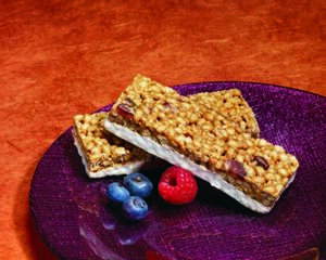 A purple plate with some granola bars and berries