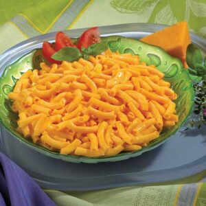 A bowl of macaroni and cheese on a table.