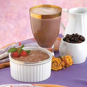 A bowl of pudding and a glass with chocolate milk.