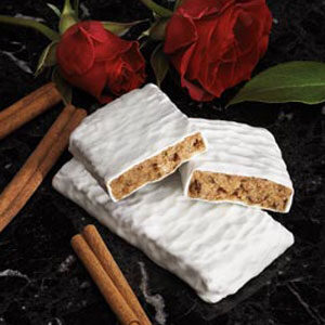 A bar of white chocolate with cinnamon sticks and roses.